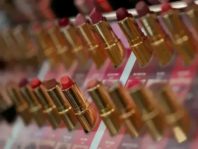 many lipsticks are lined up on a shelf