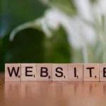 scrabble tiles spelling website on wooden surface
